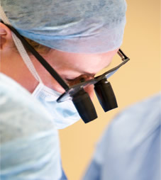 A surgeon with surgical magnifying glasses
